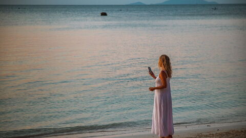 Woman on the phone on a beach