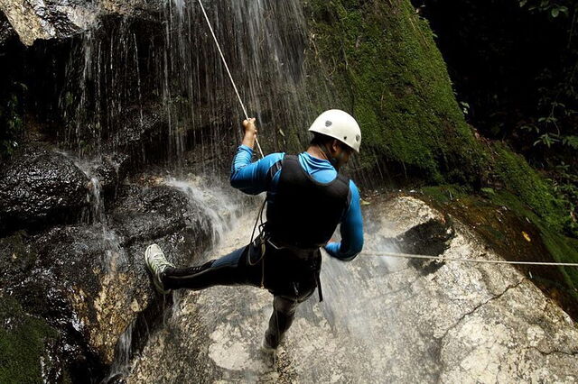 Canyoning across a waterfall