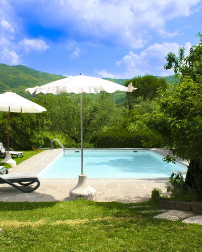 Collina dei Fiori: Swimming Pool, Hill, Outdoor Furniture, Mountain Range, Leisure, Eco Hotel, Umbrella, Resort, Garden, Shade
