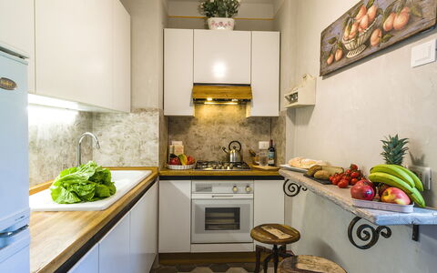 Michelangelo Cortona Apartment: Countertop, Room, Property, Interior Design, Furniture, Kitchen, Ceiling, Green, Floor, Building