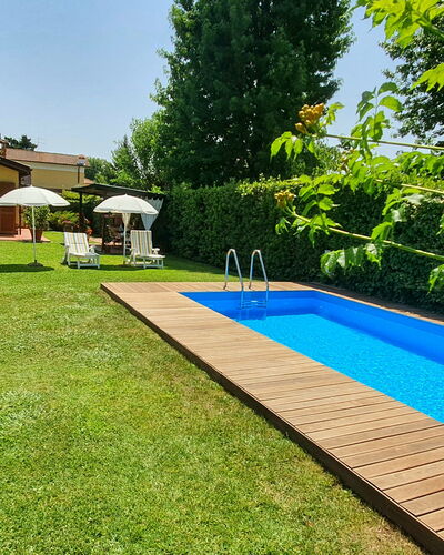 La Capannella: Plant, Shade, Tree, Sky, Swimming Pool, Building, Outdoor Furniture, Water, Real Estate, Flooring