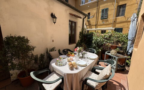 Casina Bella Di Lucca: Furniture, Table, Chair, Flowerpot, Kitchen & Dining Room Table, Outdoor Table, Houseplant, Outdoor Furniture, Coffee Table, Dining Room