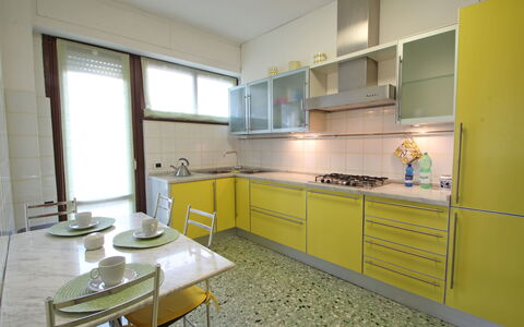 Marina Apartment: Property, Room, Furniture, Yellow, Kitchen, Building, Cabinetry, Interior Design, House, Countertop