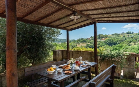 Villa Laura: Table, Plant, Furniture, Shade, Wood, Porch, Interior Design, Cloud, Tree, Leisure