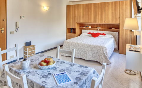 Studio Paola - Levanto: Table, Property, Furniture, Comfort, Cabinetry, Building, Wood, Textile, Interior Design, Lighting