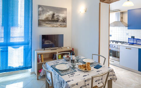 Apartments Mafalda - Levanto: Table, Furniture, Blue, Cabinetry, Azure, Wood, Interior Design, Chair, Flooring, Living Room
