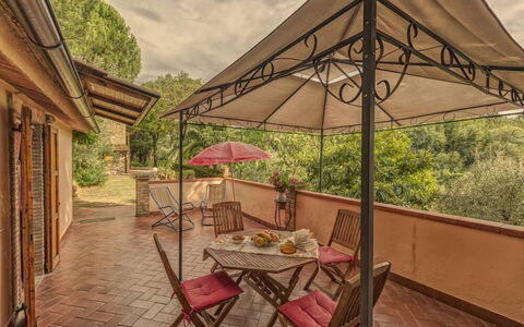 Leccino: Furniture, Table, Plant, Shade, Building, Outdoor Table, Outdoor Furniture, Chair, Tree, Wood