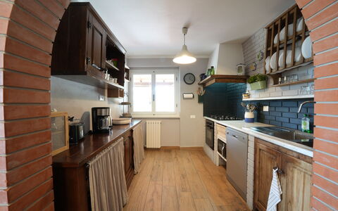 Villa Corsanico: Kitchen, Countertop, Furniture, Flooring, Kitchen Appliance, Cabinetry, Interior Design, Major Appliance, Wood, Floor