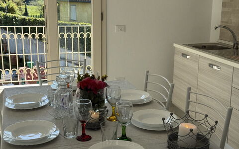 Villa al Glicine Proprietà: Furniture, Tableware, Interior Design, Table, Flooring, Kitchen & Dining Room Table, Chair, Dining Room, Lighting, Serveware