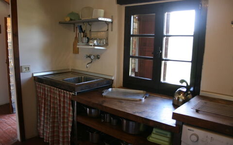 Agriturismo Bevignano: Room, Property, Furniture, Building, House, Countertop, Cabinetry, Table, Kitchen, Hardwood