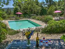 At lunch or dinner , under the shadow you can see garden and pool.